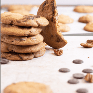Half eaten cookie next to a stack of cookies