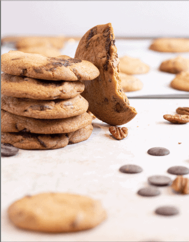 Half eaten cookie next to a stack of cookies