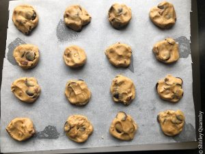Balls of raw cookie dough on a baking tray