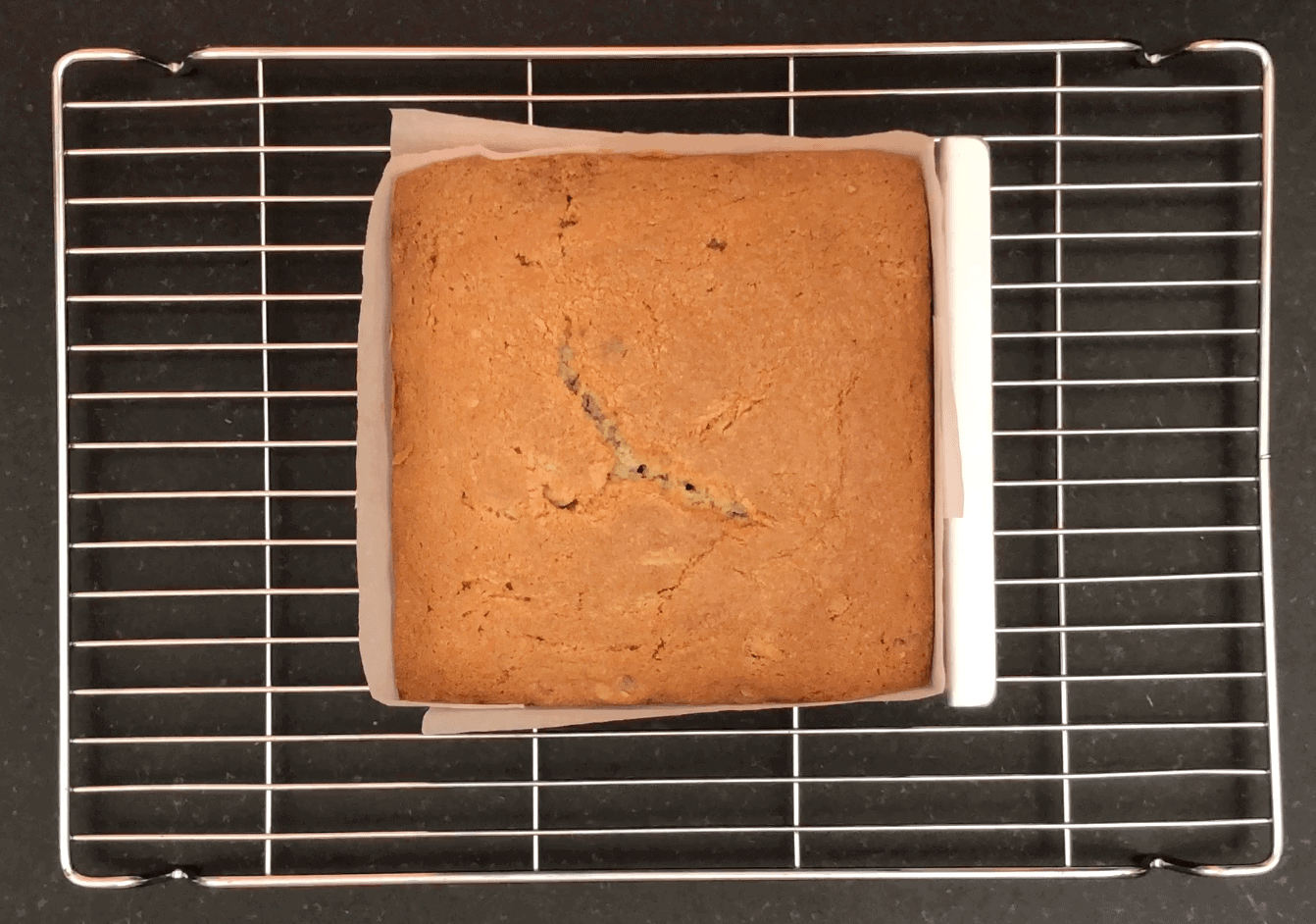 Baked square cake in a tin