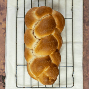 Plaited loaf of bread on a cooling rack