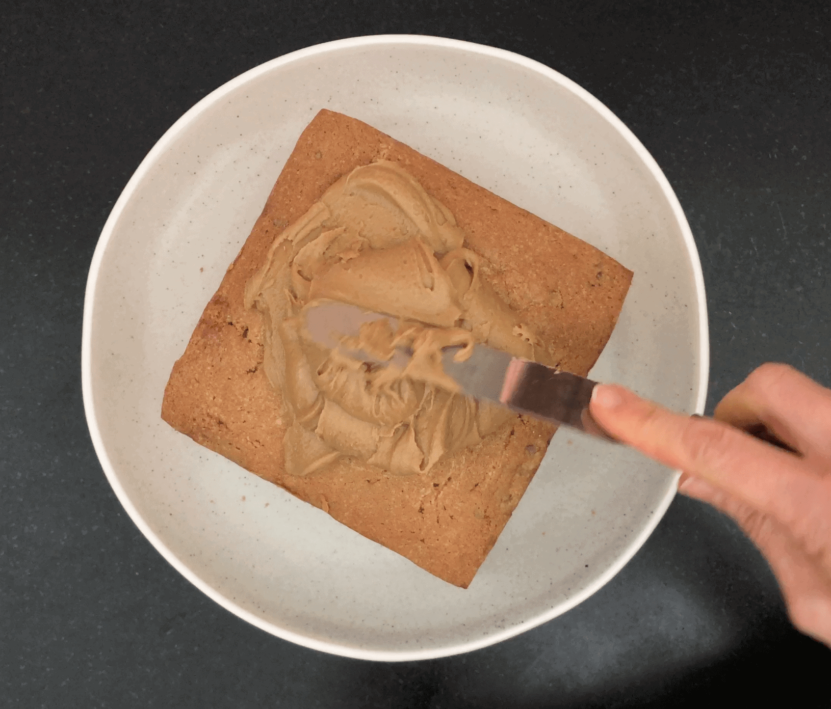 Icing square cake with brown icing