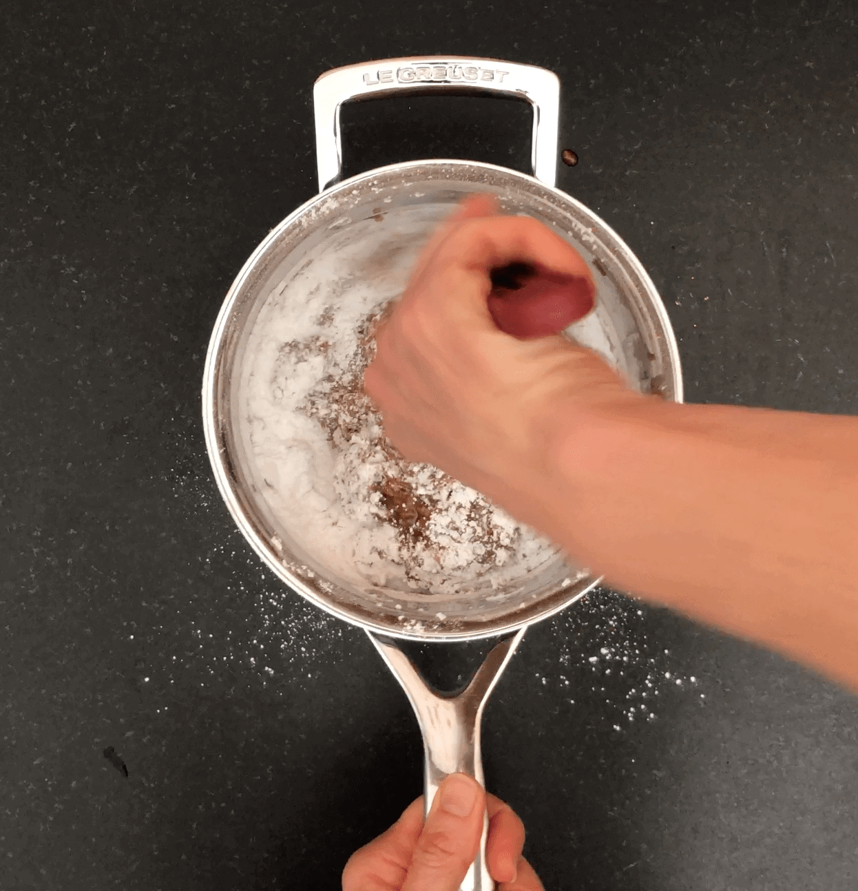 Mixing icing sugar in to a coffee mixture in a saucepan