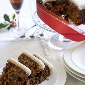 Slices of fruit xmas cake with a glass of sherry