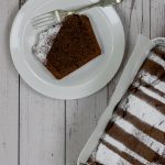 Slice of chocolate cake dusted with icing sugar